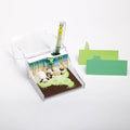 Note pad with panda design, pen, and cards on a white background